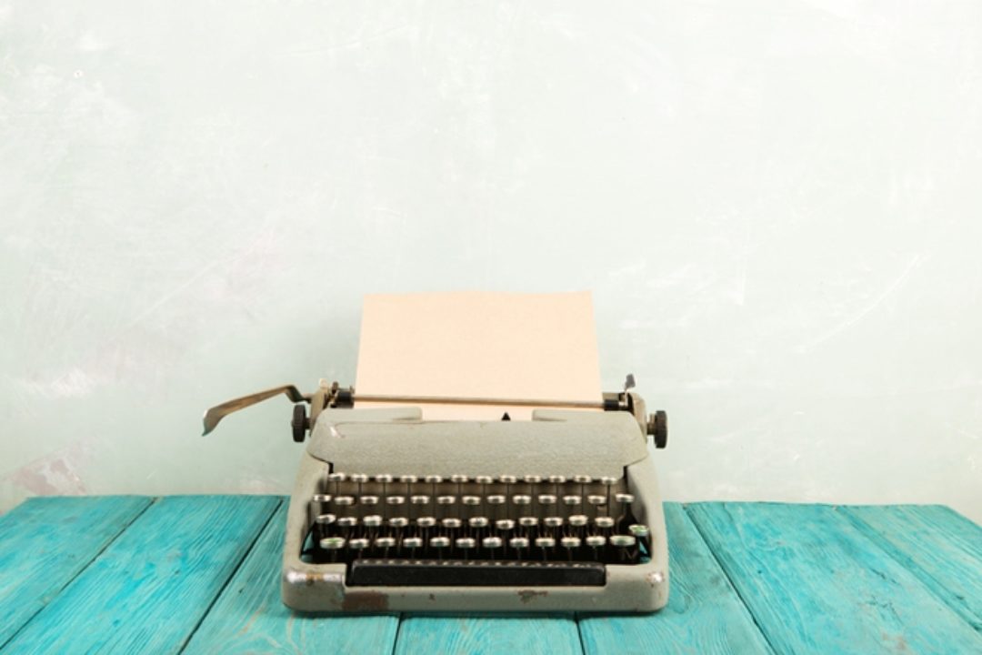 Typewriter on blue table