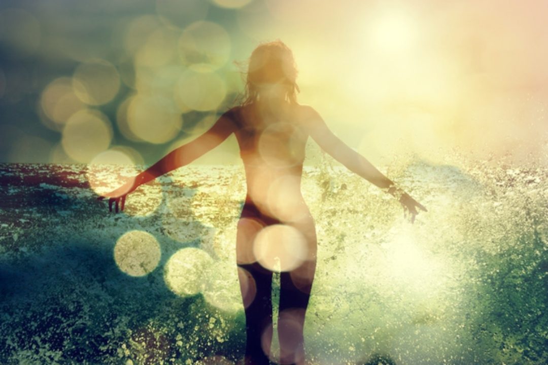 Woman on beach with light spots