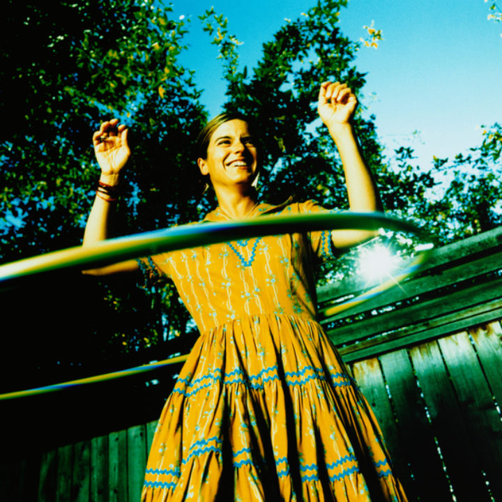 hula hooping in the sunlight under a tree