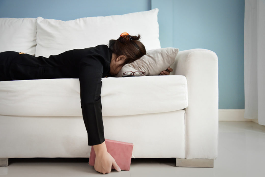 Exhausted woman on couch