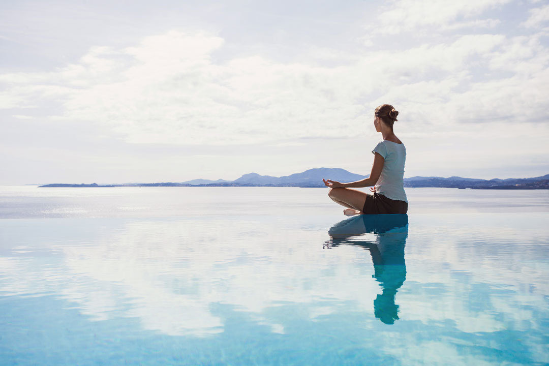 Calm scene of woman meditating on water
