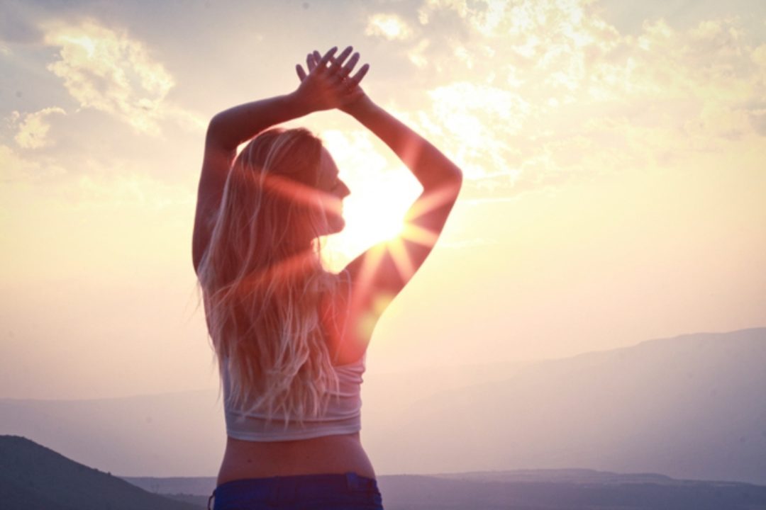 Woman stretching in morning with sun